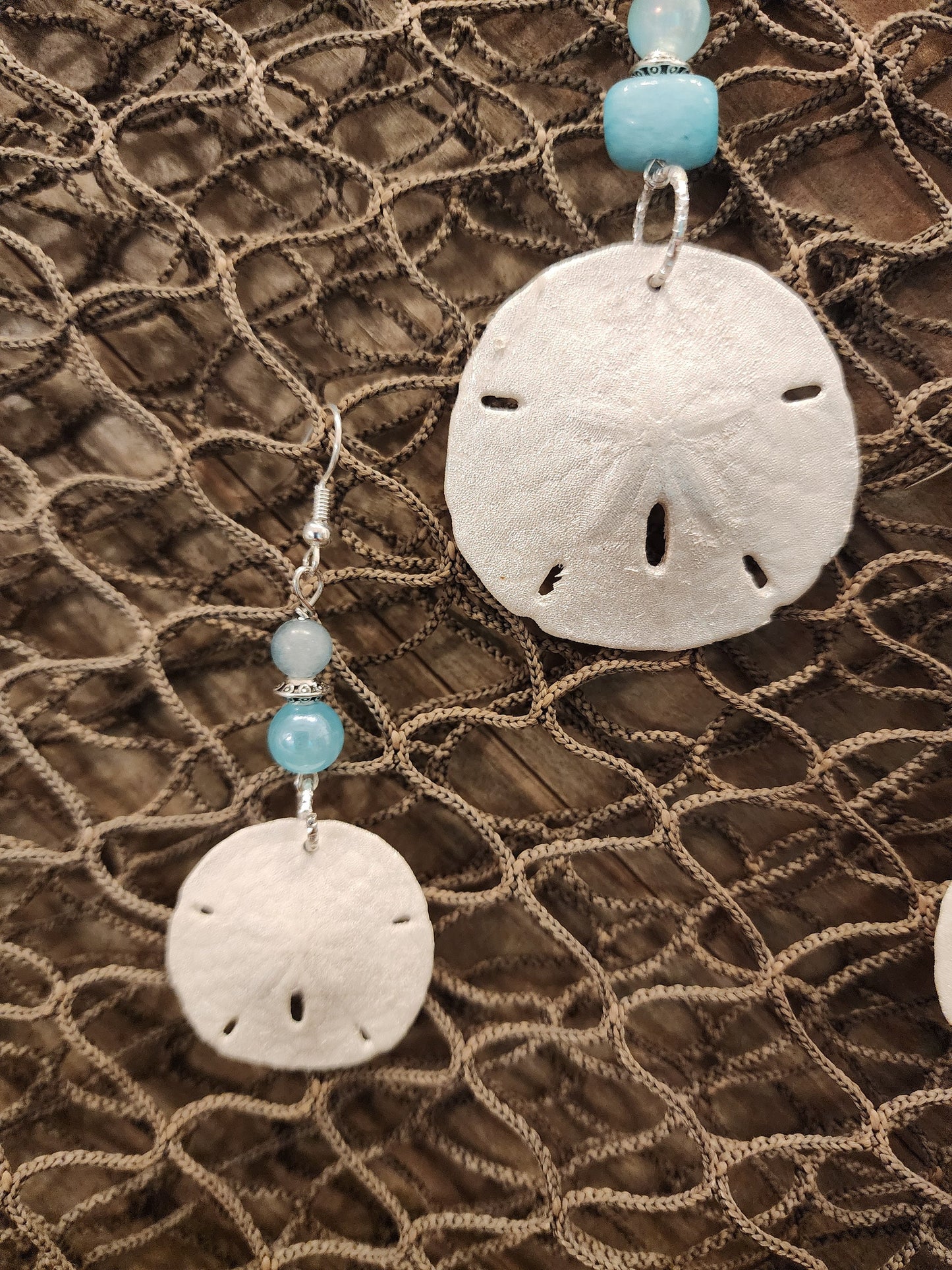 Genuine, natural handmade sand dollar pendant and earring set accented with beads in varying shades of blue. Beach jewelry set.