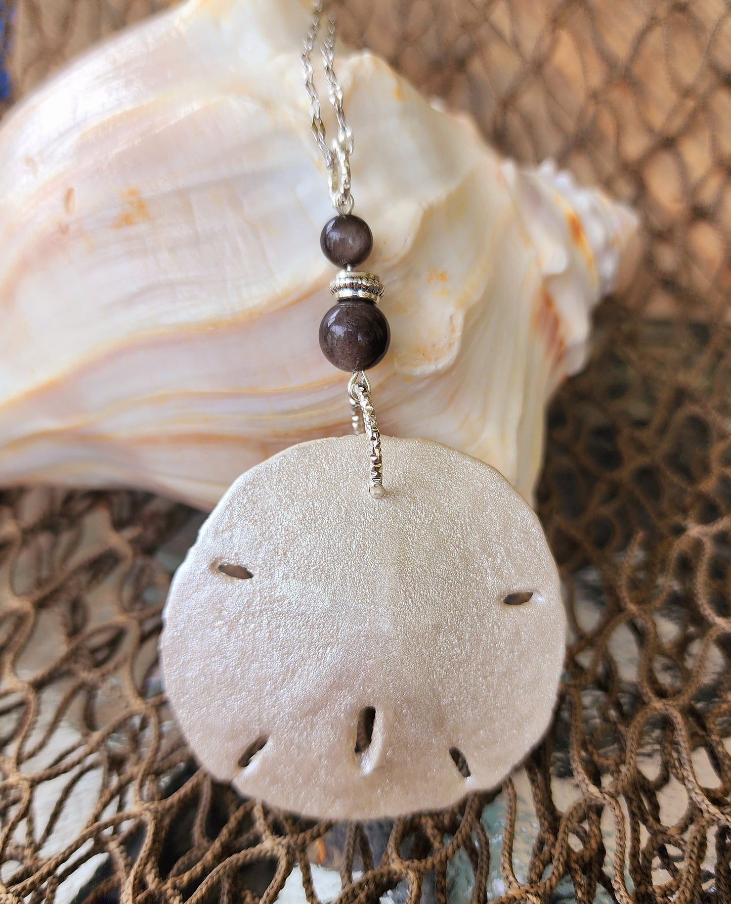 Stunning and elegant handmade sand dollar necklace and earrings set with silver obsidian bead accents. Sand dollar pendant and earrings set