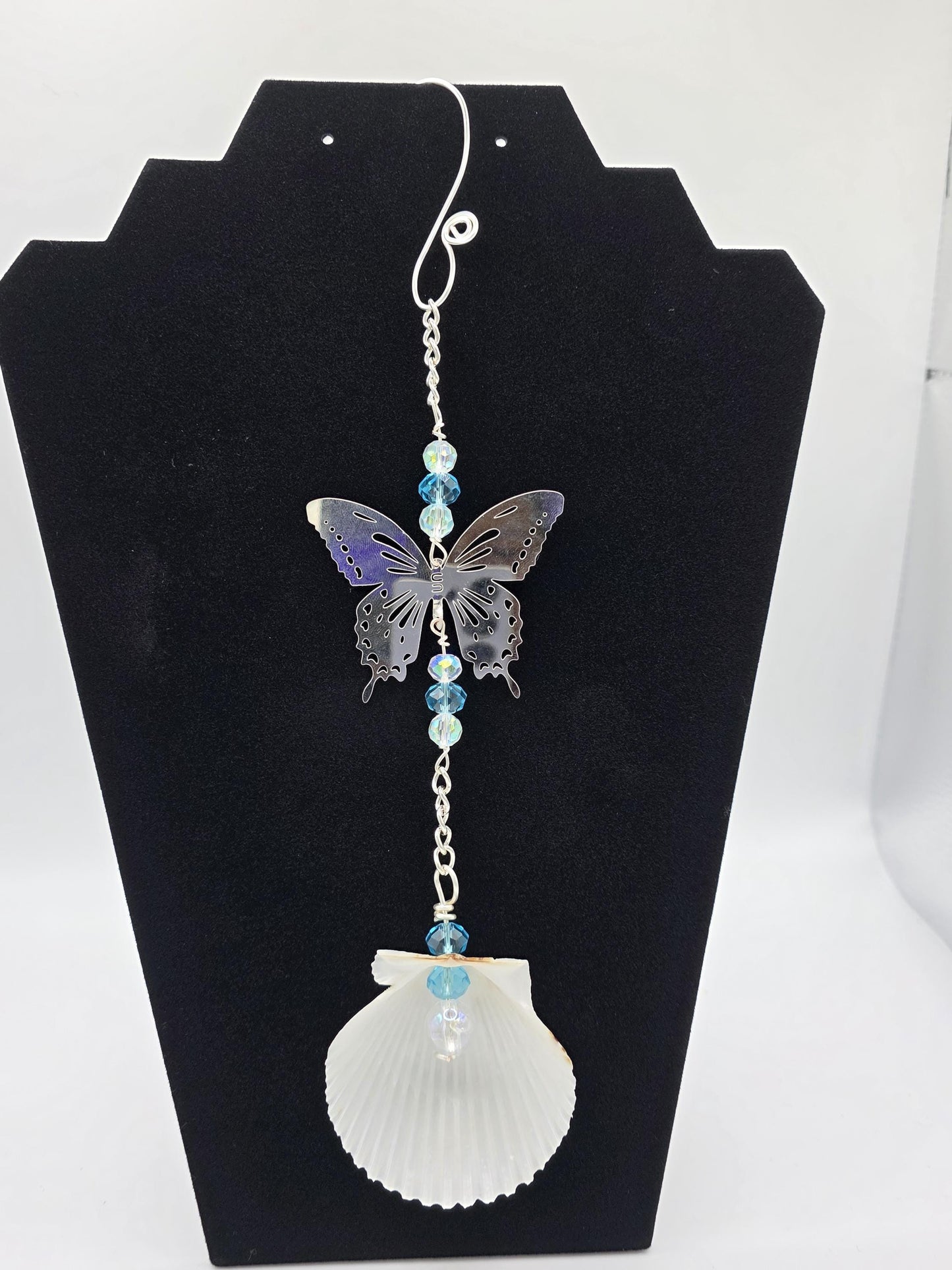 Seashell suncatcher, car charm with butterfly, blue and iridescent glass beads, and natural Florida scallop seashell. Approximate 10" long.