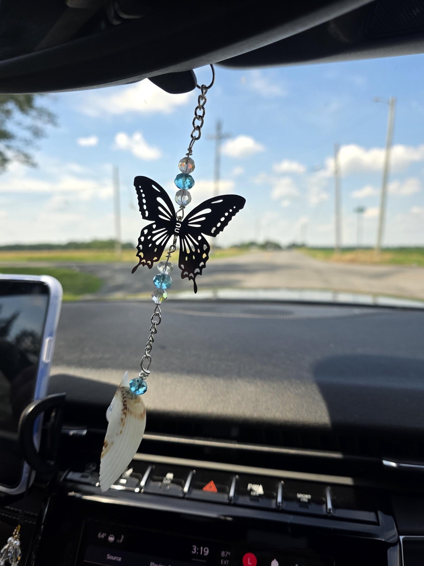 Seashell suncatcher, car charm with butterfly, blue and iridescent glass beads, and natural Florida scallop seashell. Approximate 10" long.