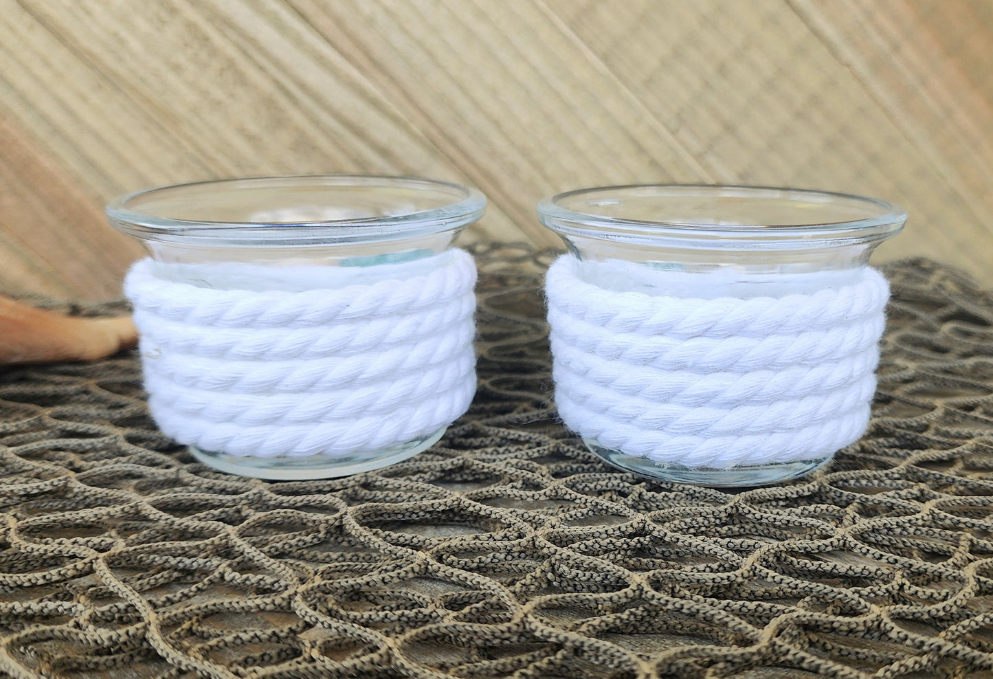 Set of 2 coastal candle holders for tealight or votive candles, wrapped in white rope with turquoise seaglass, and seashell accents.