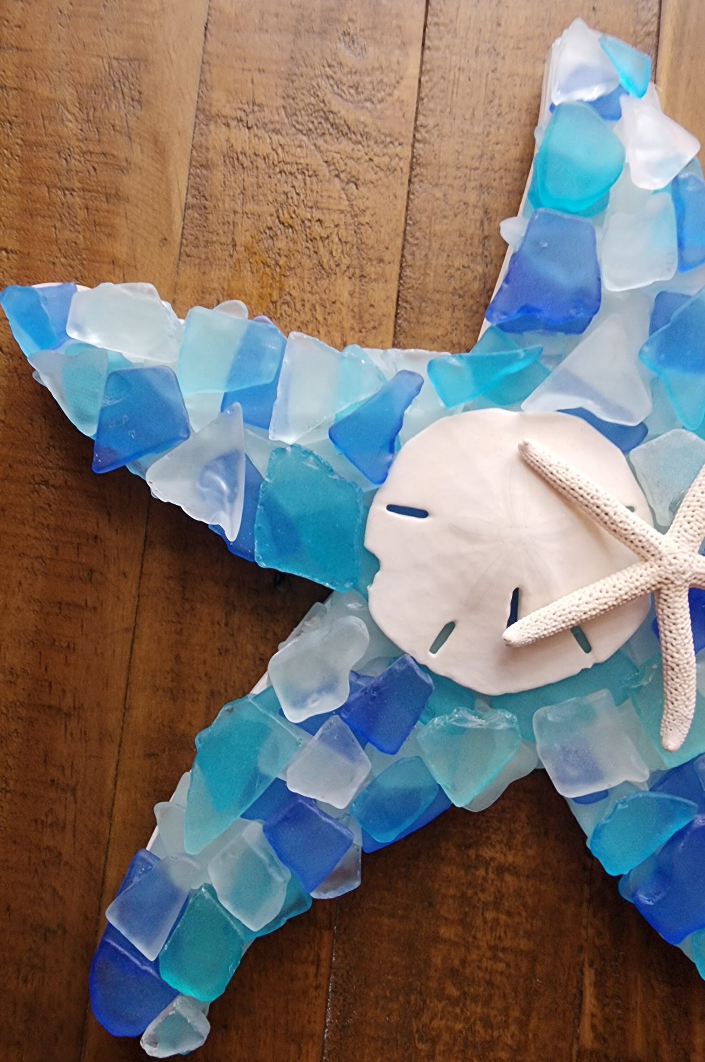 Sea glass starfish wall art hanging (12"x12") in blue, aqua, turquoise and white, finished with a sand dollar and starfish.