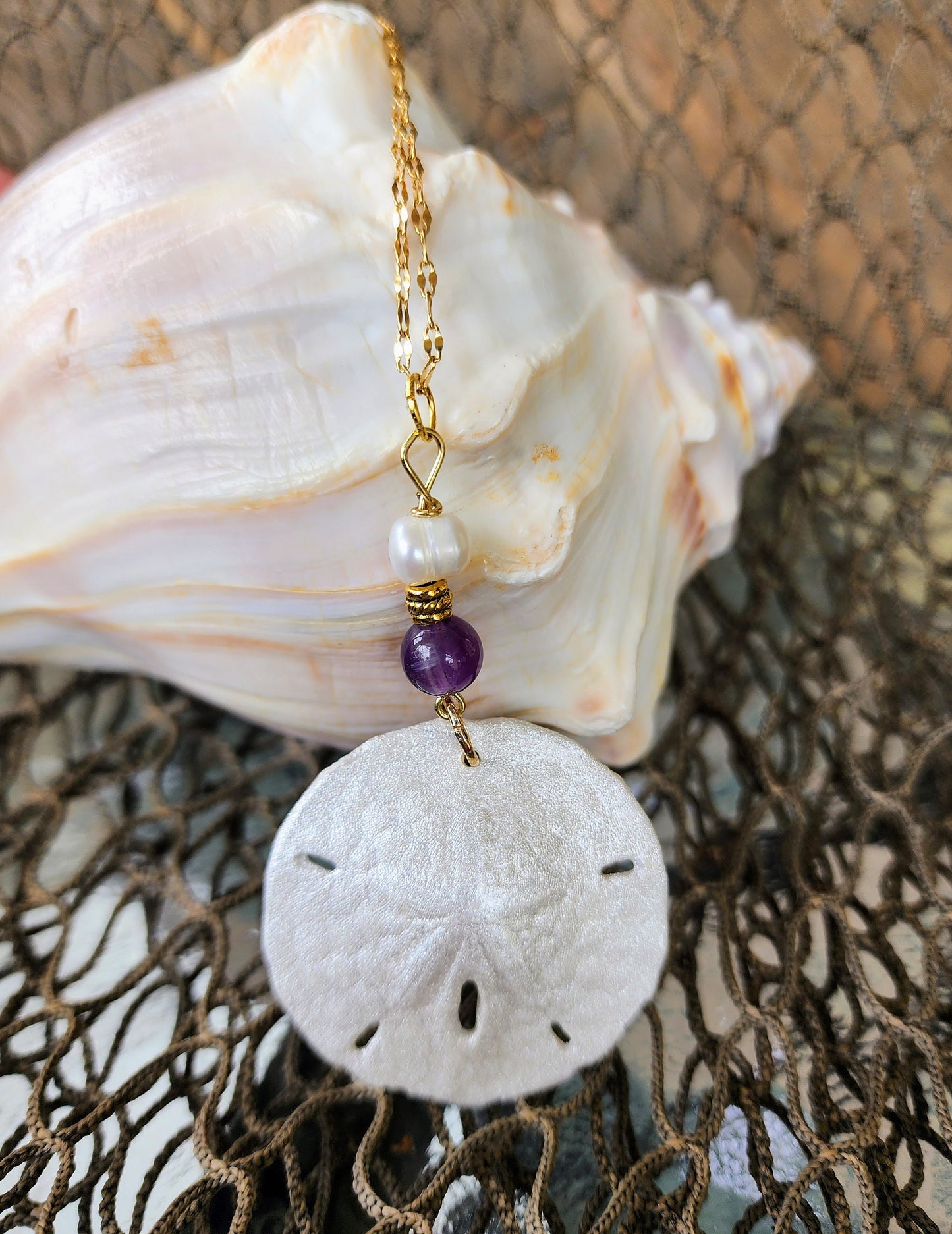 Genuine handmade sand dollar necklace, accented with amethyst and fresh water pearl beads. Natural sand dollar pendant. Boho beach jewelry.