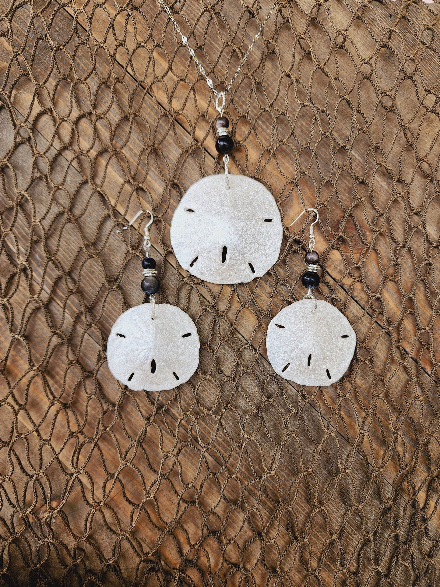 Stunning and elegant handmade sand dollar necklace and earrings set with silver obsidian bead accents. Sand dollar pendant and earrings set