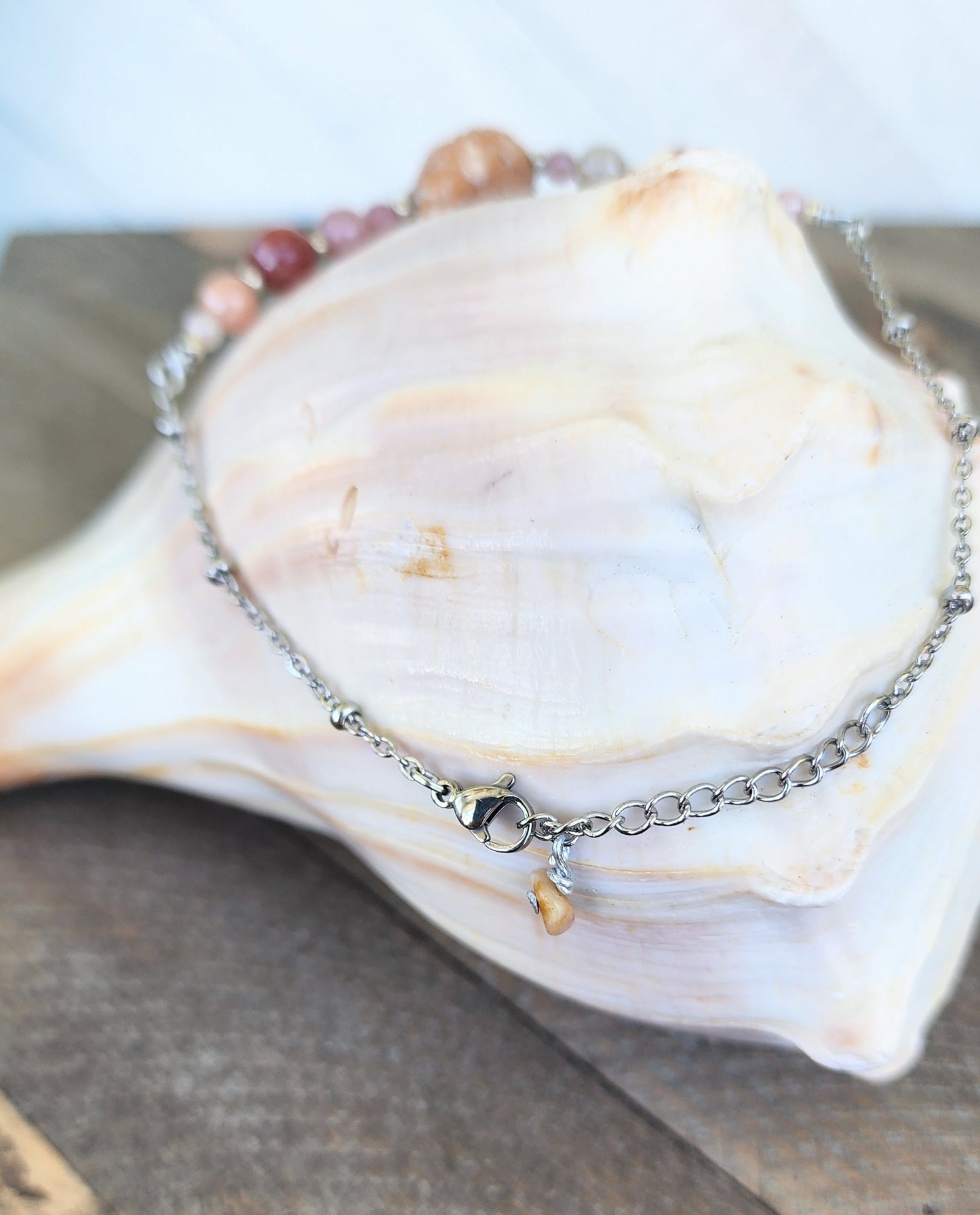 Genuine turban shell bracelet or anklet accented with semi-precious sun stone beads on silver beaded cable style stainless adjustable chain.
