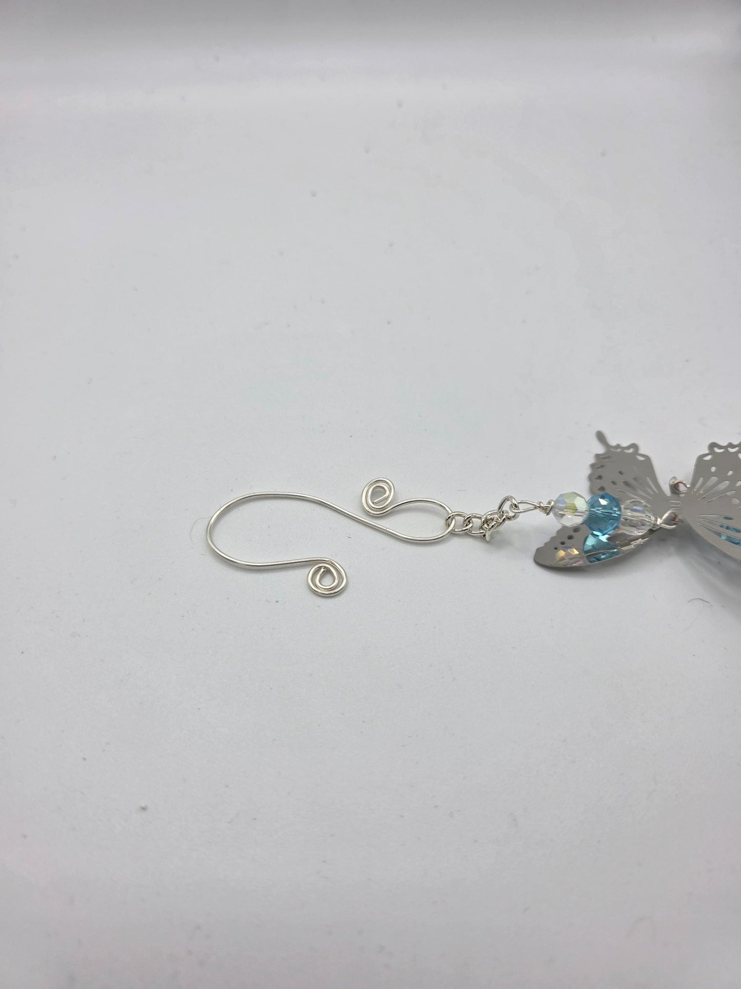 Seashell suncatcher, car charm with butterfly, blue and iridescent glass beads, and natural Florida scallop seashell. Approximate 10" long.