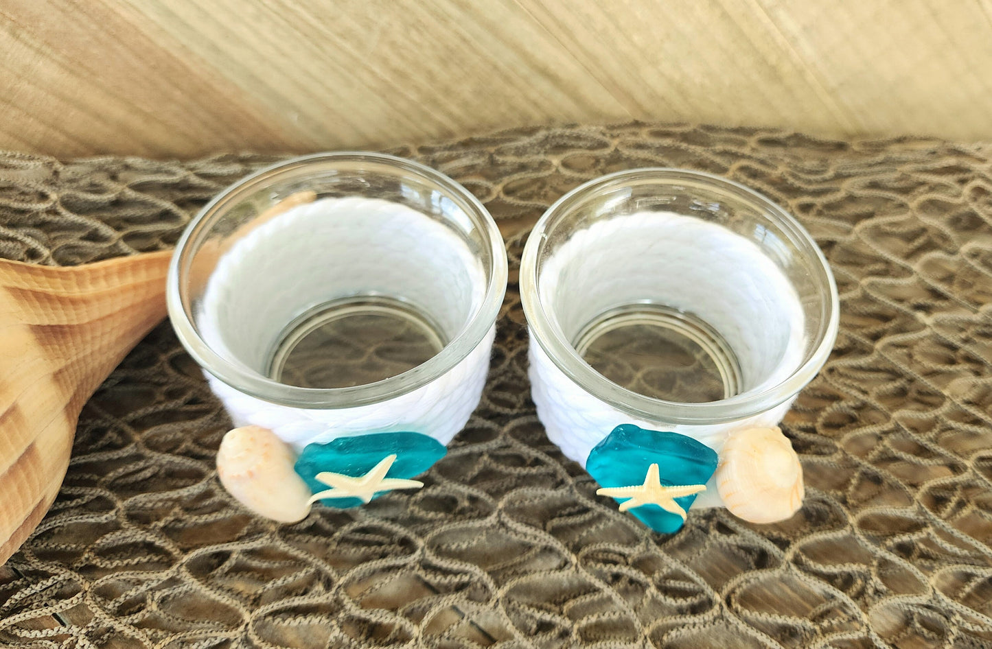 Set of 2 coastal candle holders for tealight or votive candles, wrapped in white rope with turquoise seaglass, and seashell accents.