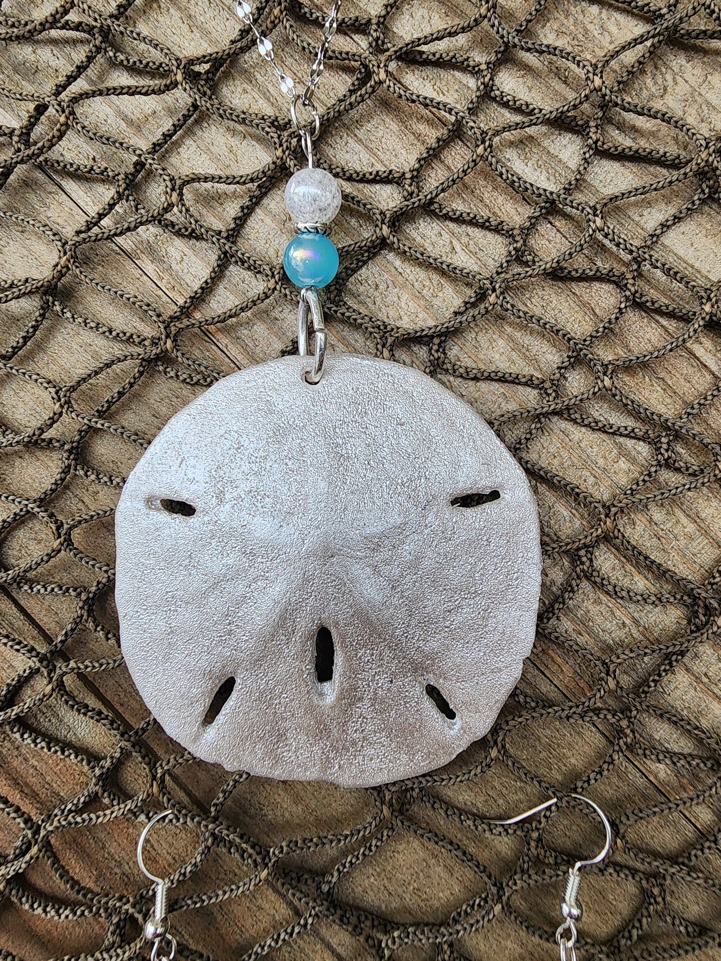 Handmade natural sand dollar necklace and earring set accented with aqua and white crackle beads. Perfect for beach wedding or bridesmaids.