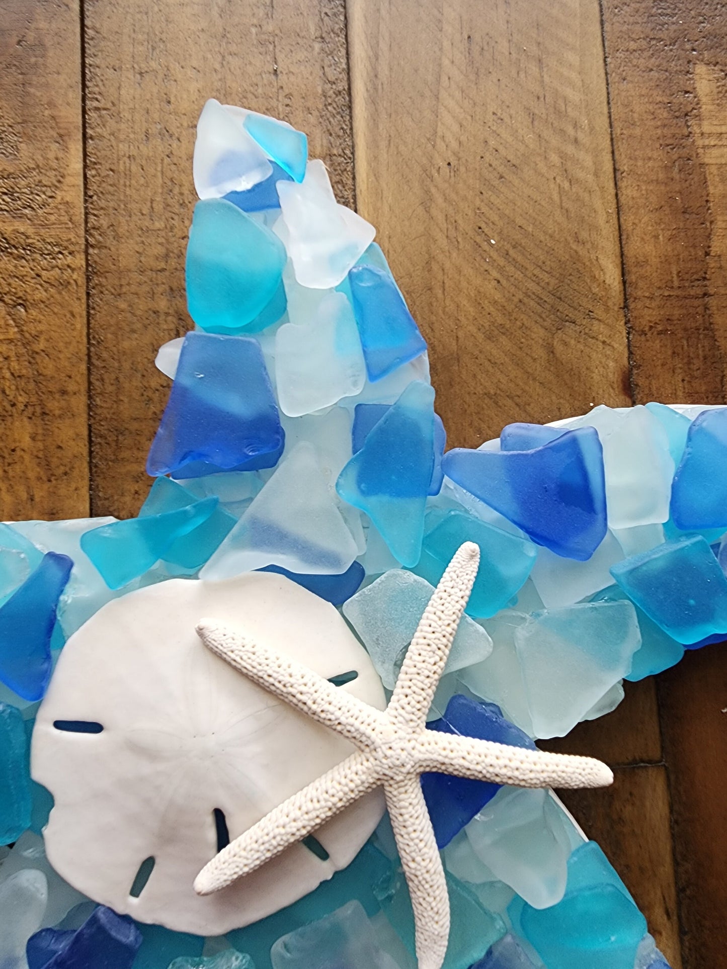 Sea glass starfish wall art hanging (12"x12") in blue, aqua, turquoise and white, finished with a sand dollar and starfish.