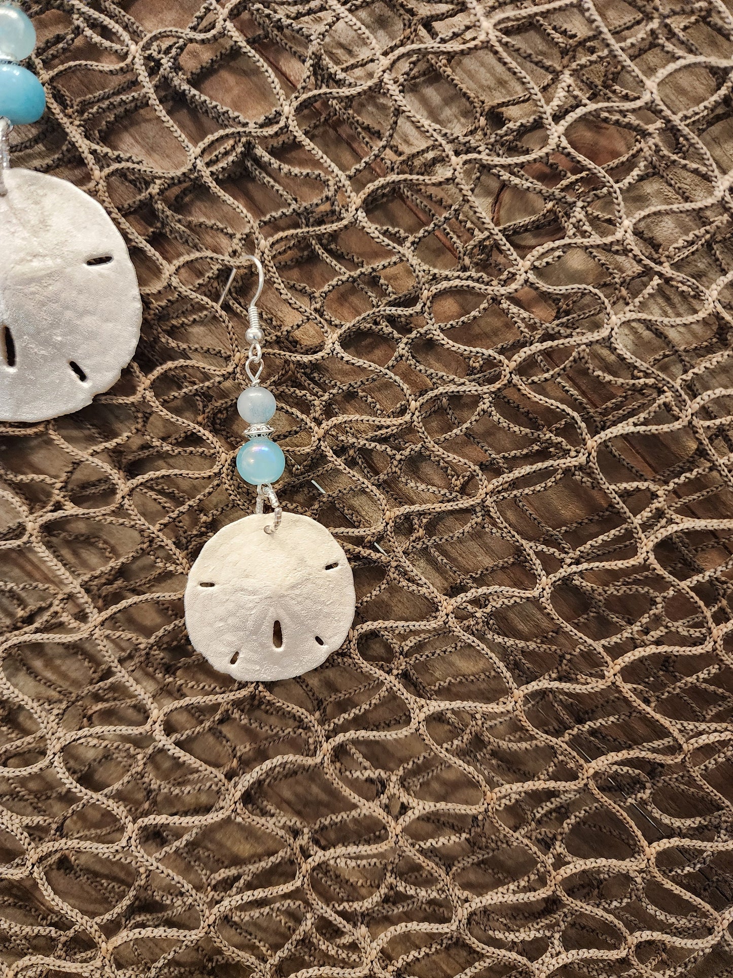 Genuine, natural handmade sand dollar pendant and earring set accented with beads in varying shades of blue. Beach jewelry set.
