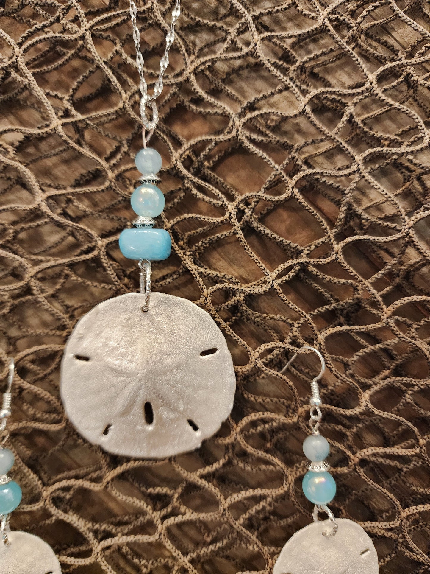 Genuine, natural handmade sand dollar pendant and earring set accented with beads in varying shades of blue. Beach jewelry set.